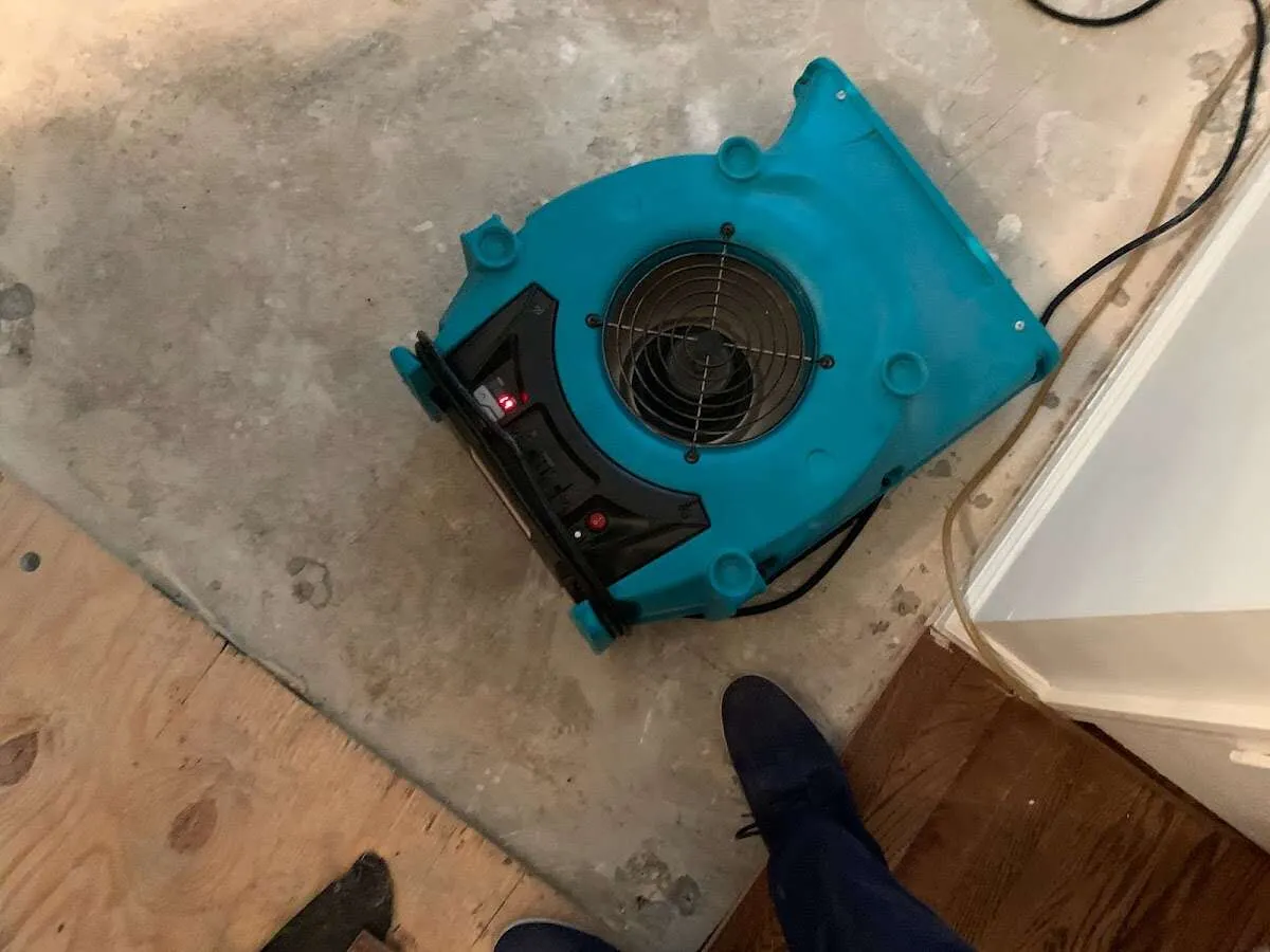 Air mover drying subfloor during Commercial Water Damage Restoration in Holly Springs
